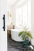 greige design shop + interiors master bathroom herringbone slate floors black with white grout freestanding tub brass fixtures