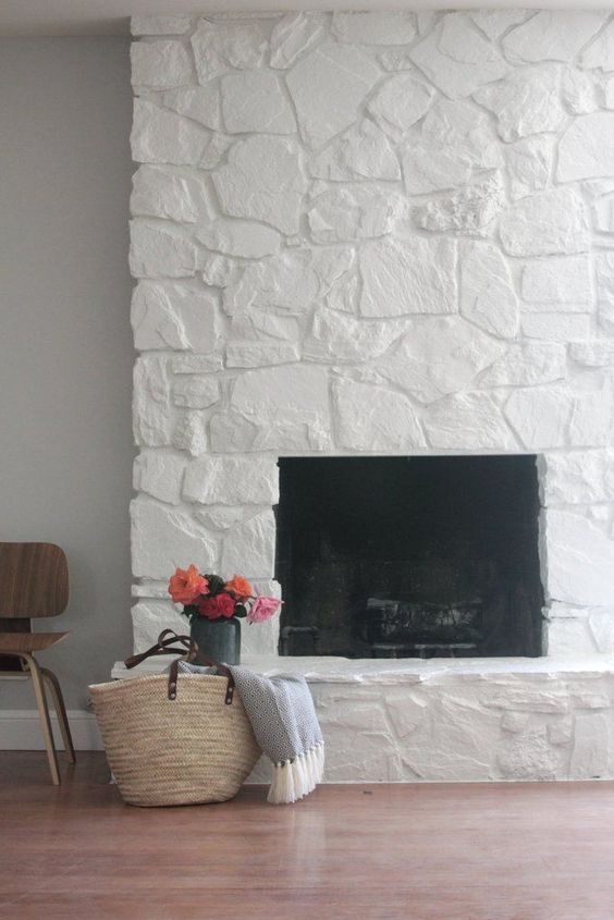 greige design shop + interiors paiting the stone fireplace white